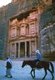 Jordan: A man leads a tourist on horseback  in front of Al Khazneh (The Treasury), Petra