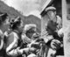 China / Tibet: Chinese propaganda image of happy Tibetans offering butter tea to a Han Chinese People's Liberation Army (PLA) tractor driver at the time of the Great Proletarian Cultural Revolution (1966-1976)